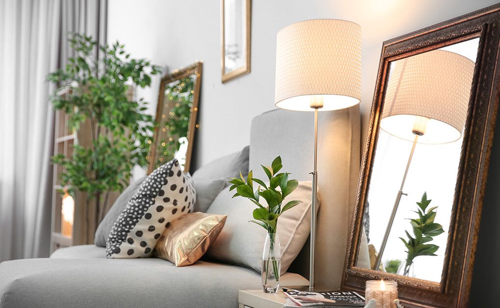 Up close view of Couch, Lamp and mirror from a family room