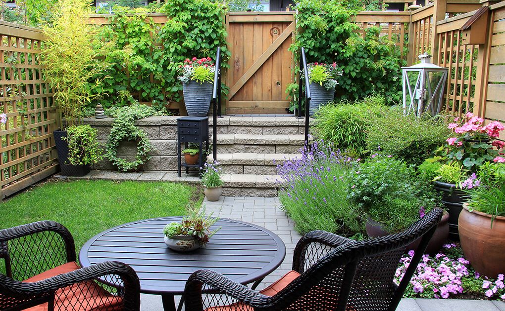 Outdoor Patio with Flowers and Wood Gate